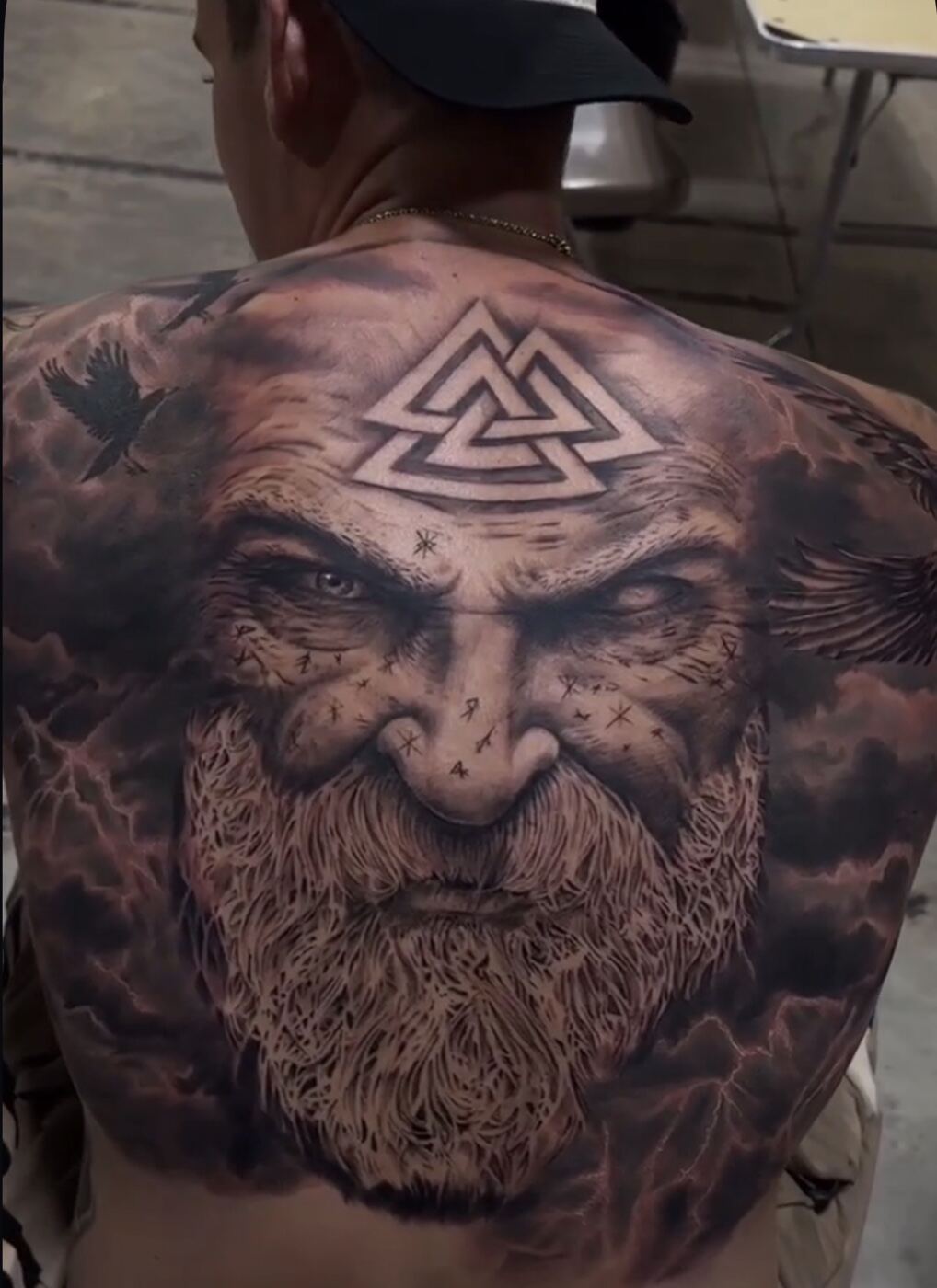Black and grey realism back piece, Norse warrior with valknut symbol
